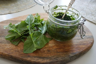 High angle view of dandelion pesto sauce on cutting board against gray background