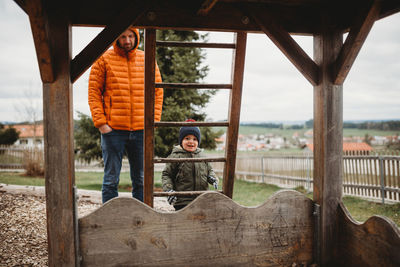 Boy standing by railing