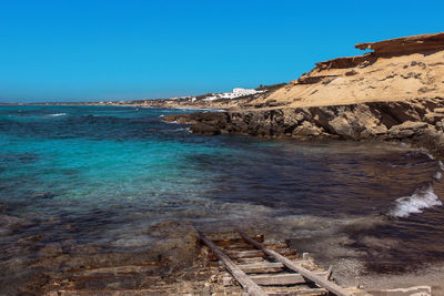 Scenic view of sea against clear blue sky