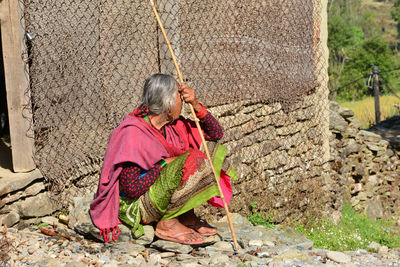 Rear view of woman working on walkway