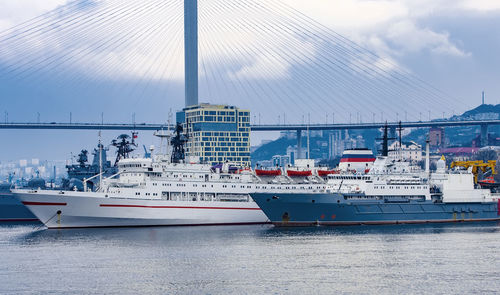 Harbor by sea against sky in city