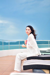 Portrait of young woman sitting on terrace