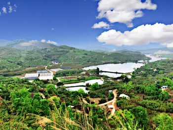 Scenic view of landscape and houses against sky