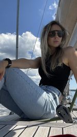 Portrait of young woman sitting at beach