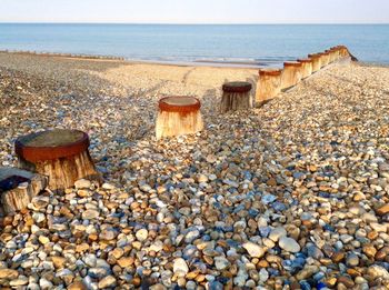 Pebbles on beach against sky