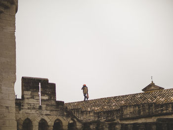 Low angle view of man against clear sky