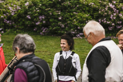 Smiling senior woman with male and females during kayaking course