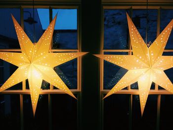 Illuminated street light against sky