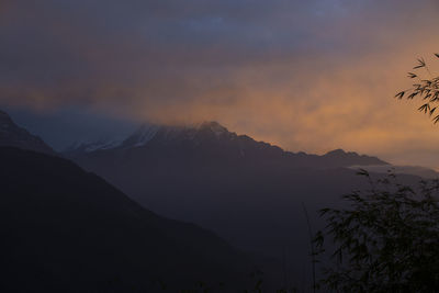 Scenic view of silhouette mountains against sky at sunset