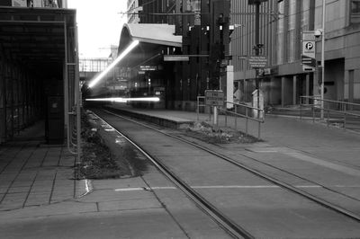 Railroad tracks amidst buildings in city