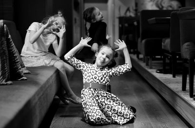 Rear view of women sitting on floor