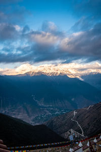 Scenic view of snowcapped mountains against cloudy sky