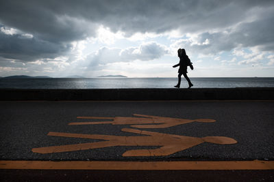 Woman walking in the park near the sea