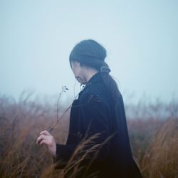 Woman standing on grassy field