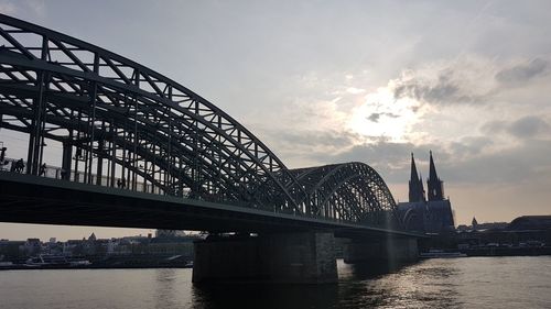 Bridge over river with city in background