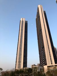 Low angle view of modern buildings against clear blue sky