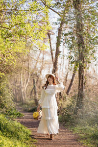 Rear view of woman standing in forest