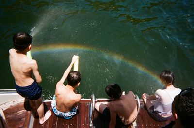 High angle view of friends on pier over sea