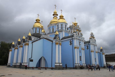 Low angle view of building against cloudy sky