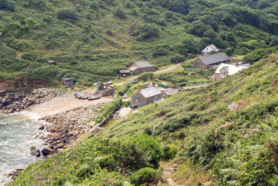 High angle view of houses amidst trees and buildings