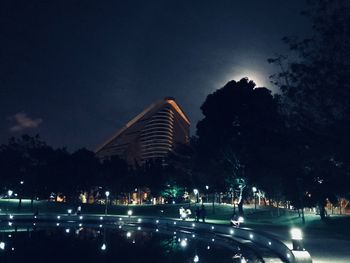 Illuminated building against sky at night