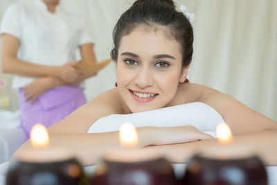 Young woman lying on massage table in spa