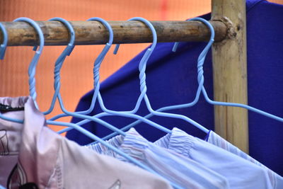 Close-up of clothes hanging on rack