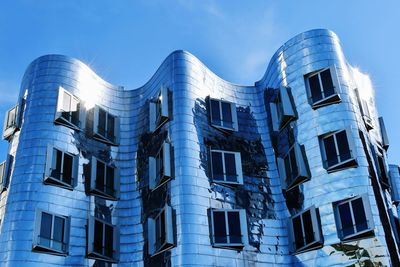 Low angle view of buildings against blue sky