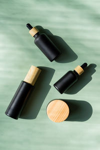 Unbranded set of beauty treatment cosmetics package in black frosted glass with bamboo lid. 