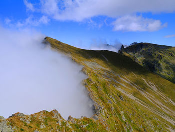 Panoramic view of land and mountains against sky