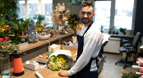 Portrait of young man holding food at home