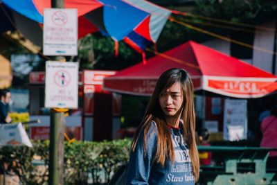 Portrait of young woman in city