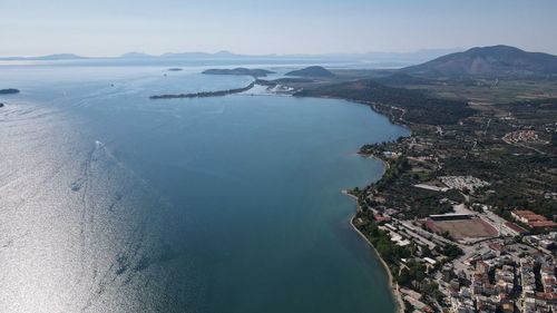 High angle view of city by sea against sky