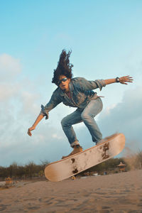 Low angle view of person jumping on shore