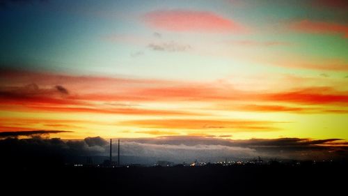 Scenic view of silhouette mountains against sky during sunset