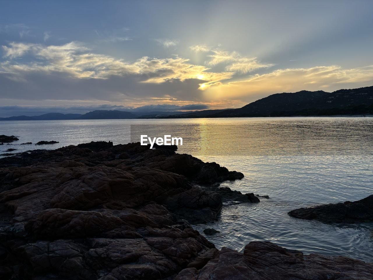 water, sky, sea, beauty in nature, scenics - nature, cloud, land, beach, ocean, horizon, body of water, nature, coast, sunset, rock, shore, tranquility, dusk, tranquil scene, reflection, wave, bay, environment, landscape, evening, seascape, no people, mountain, travel destinations, sunlight, dramatic sky, outdoors, coastline, idyllic, travel, horizon over water, non-urban scene, sun, holiday