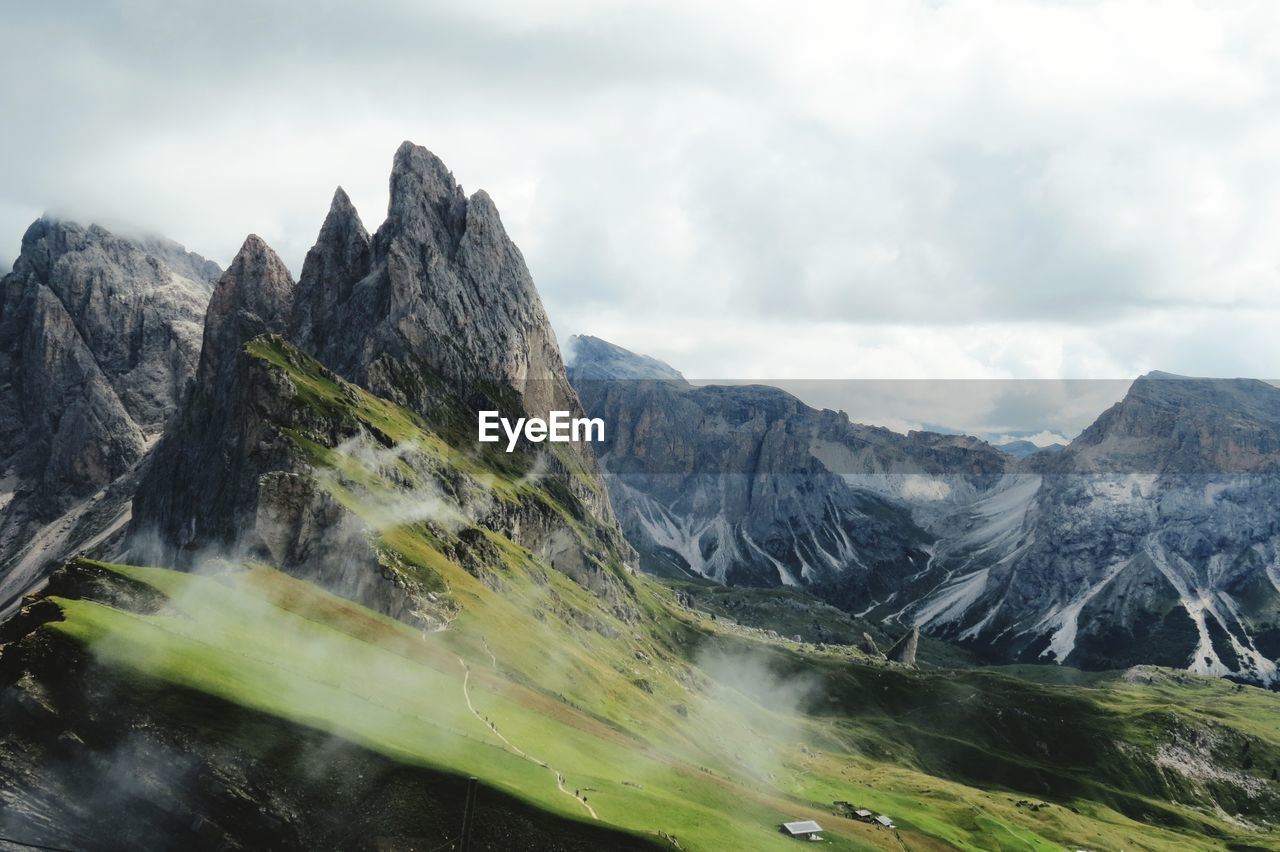 Scenic view of mountains against cloudy sky