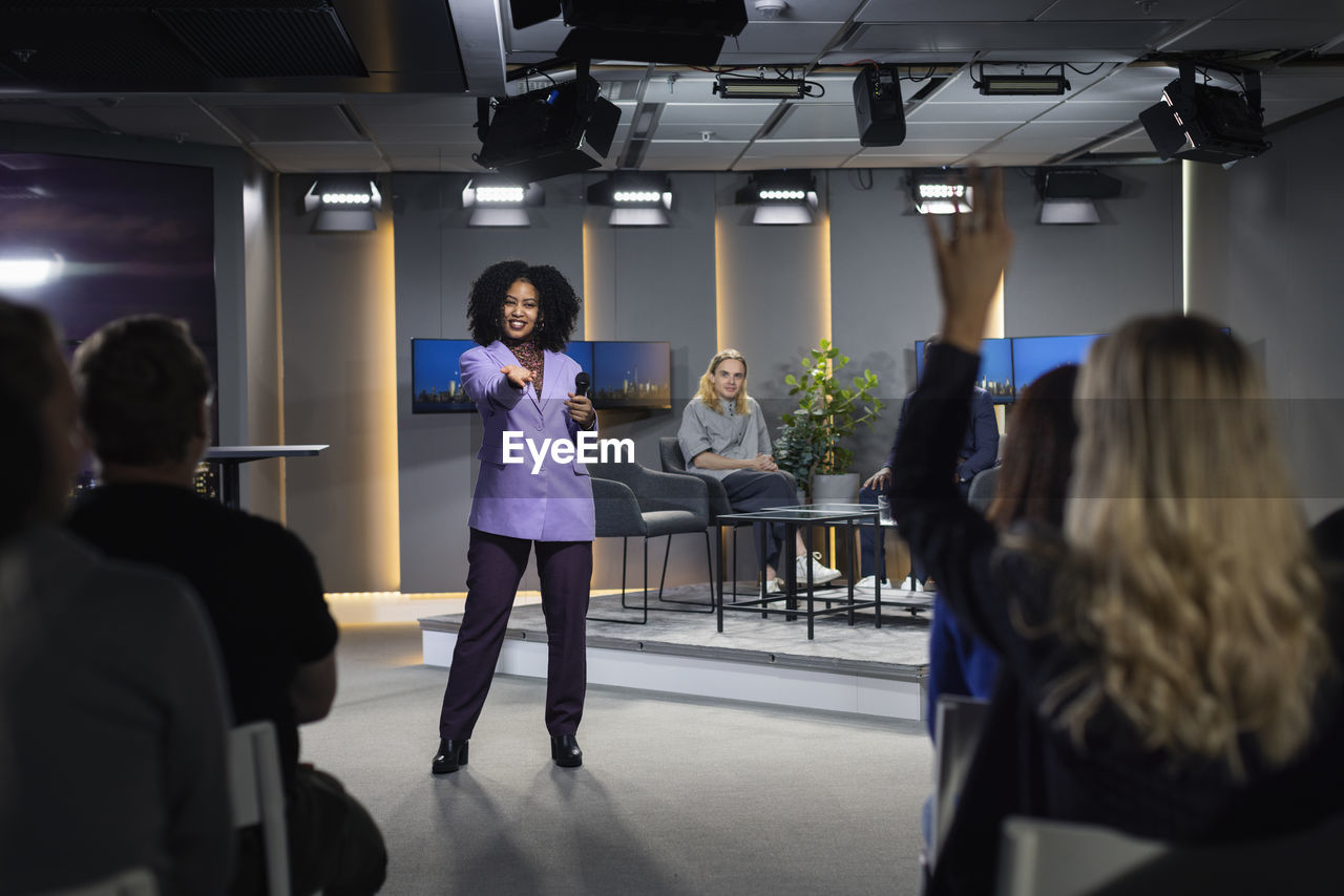 Tv show audience member raising hand