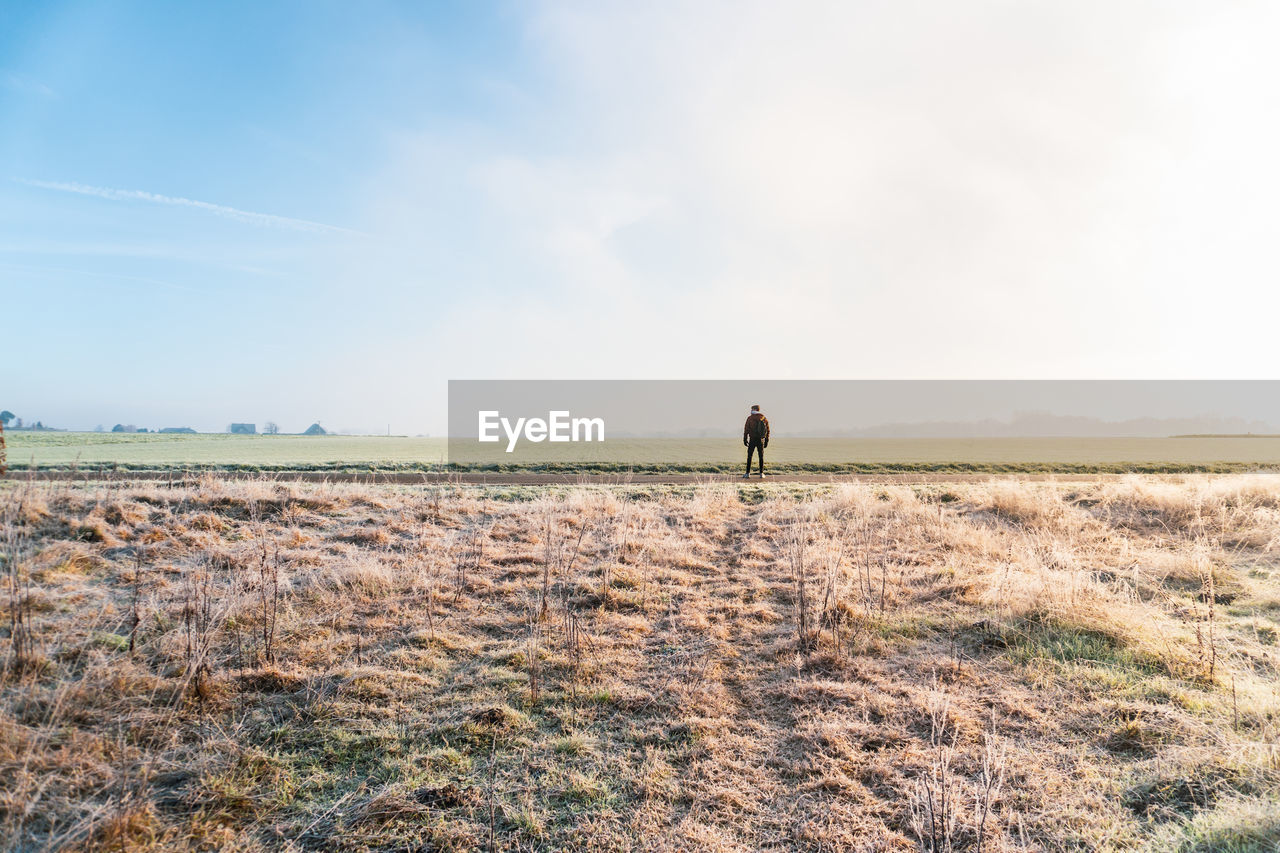 WOMAN WALKING ON FIELD