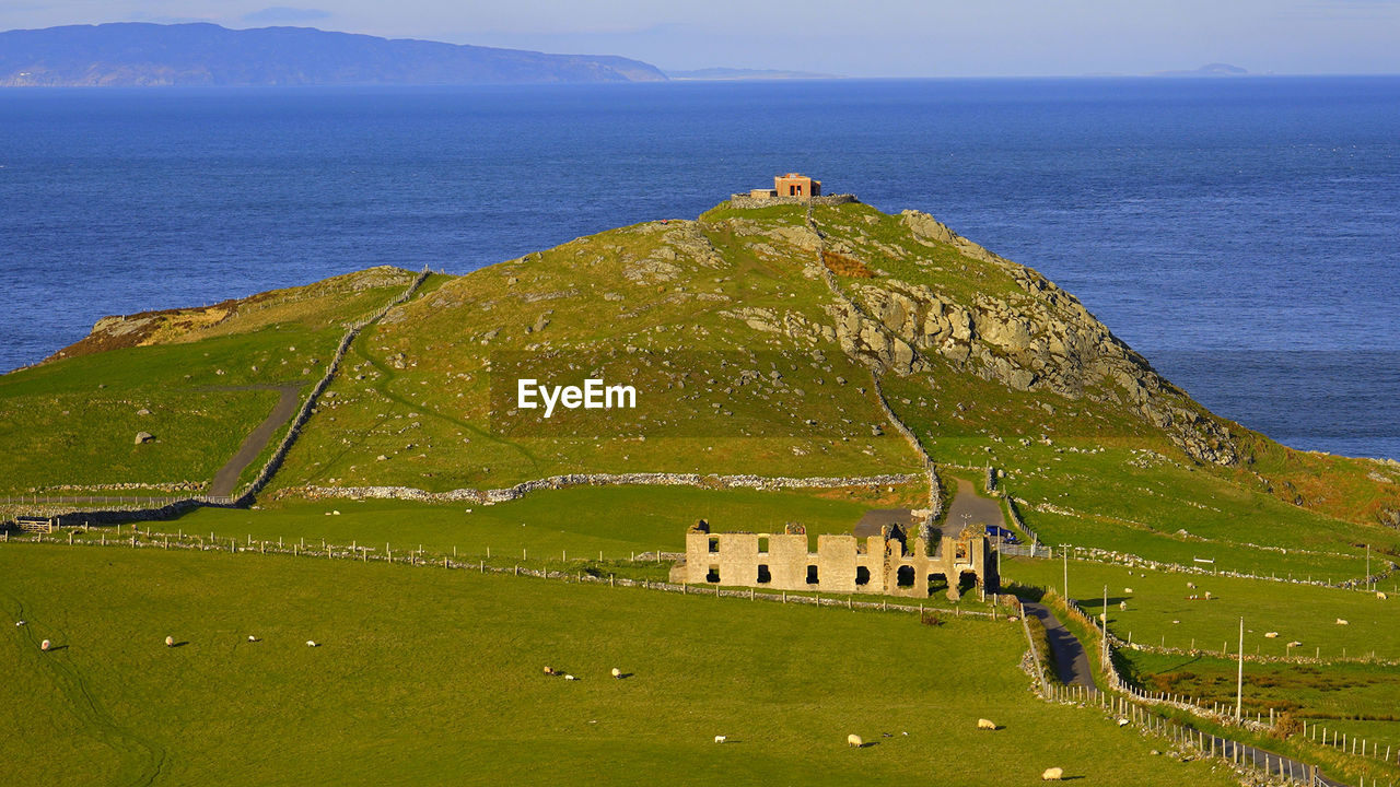 scenic view of sea and houses against sky