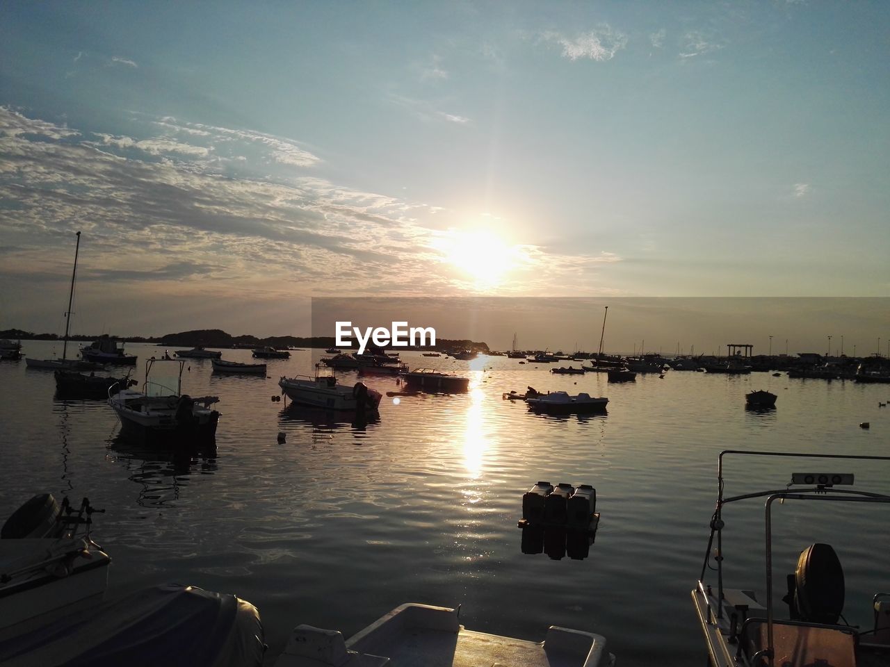 VIEW OF BOATS IN SEA AT SUNSET