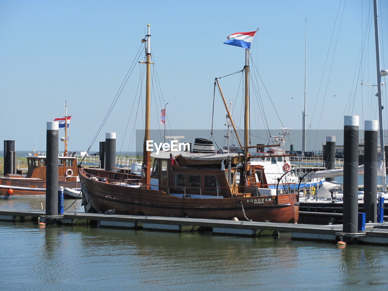 BOATS MOORED AT HARBOR