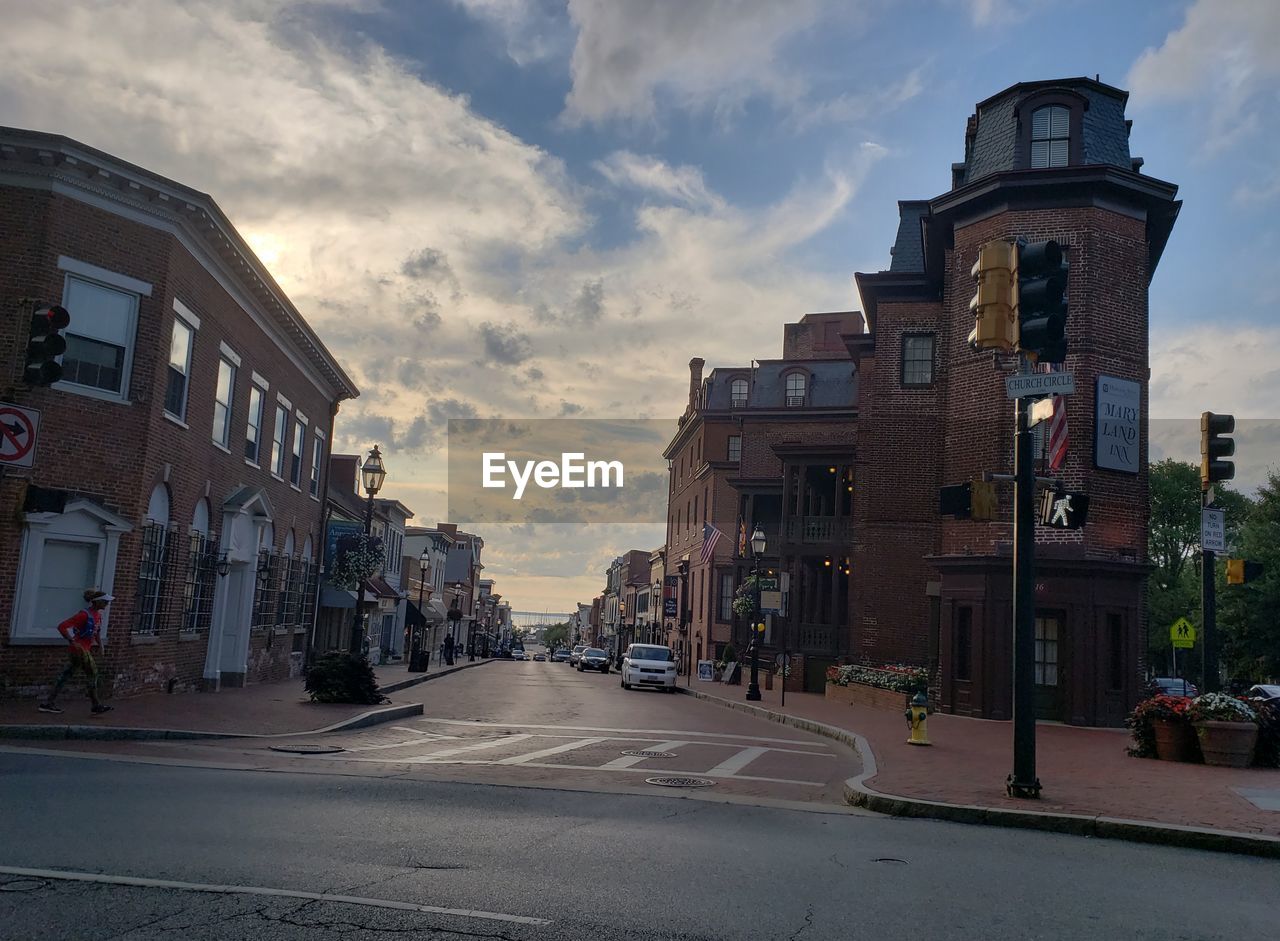 ROAD AMIDST BUILDINGS AGAINST SKY