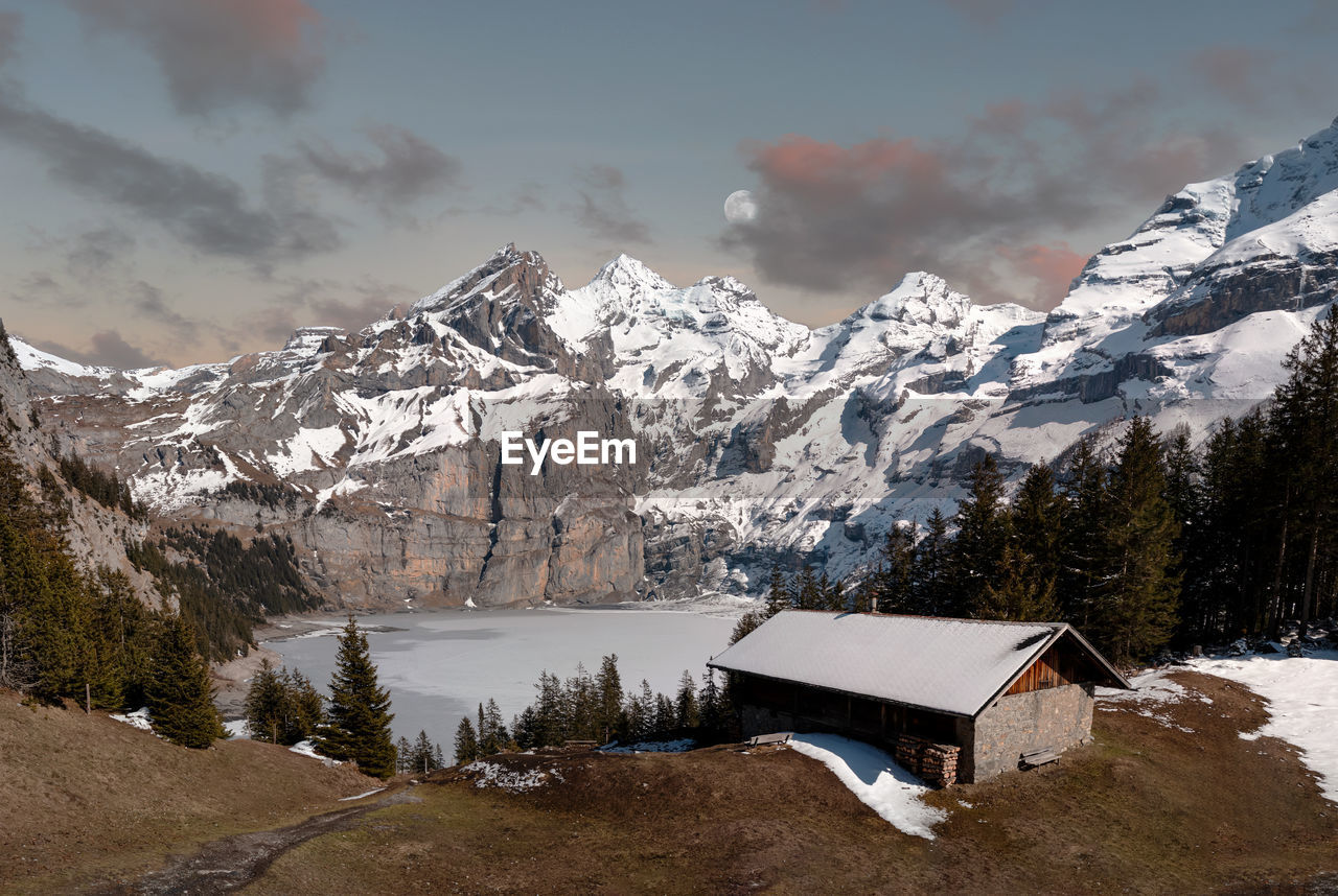 Panoramic winter landscape with frozen lake oeschinen and snow covered mountains