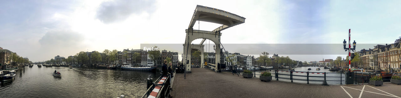 PANORAMIC VIEW OF BRIDGE OVER RIVER