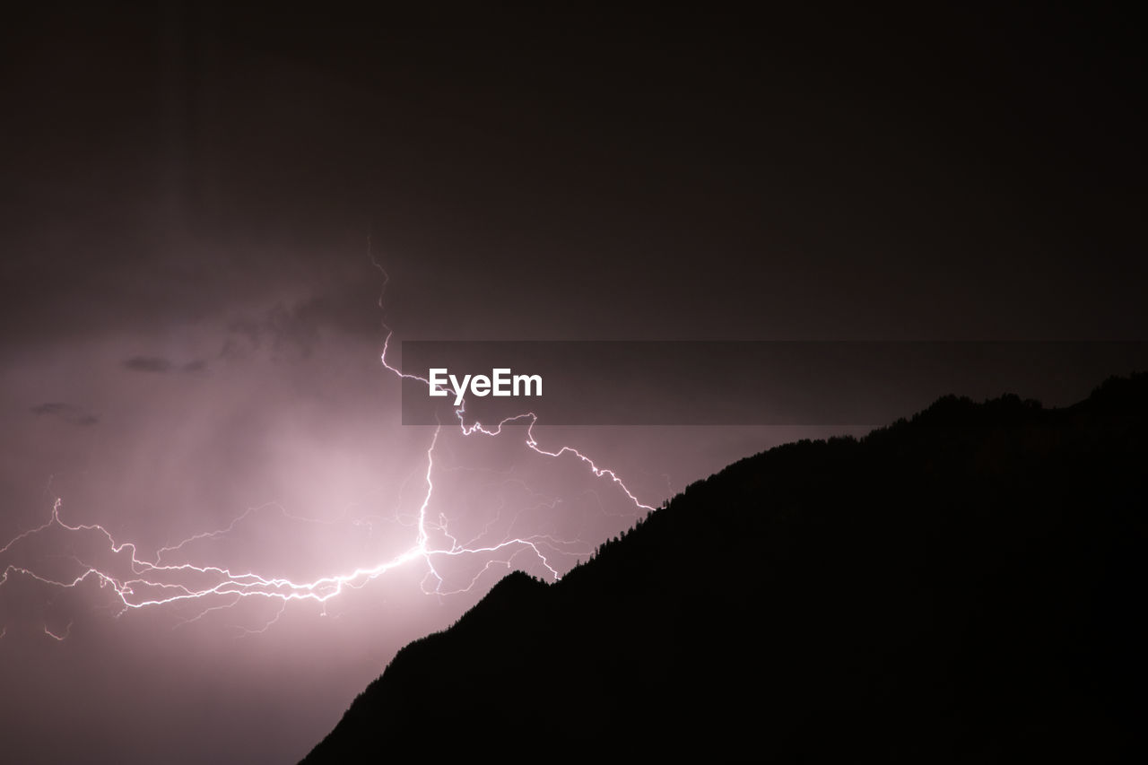 Low angle view of lightning in sky at night