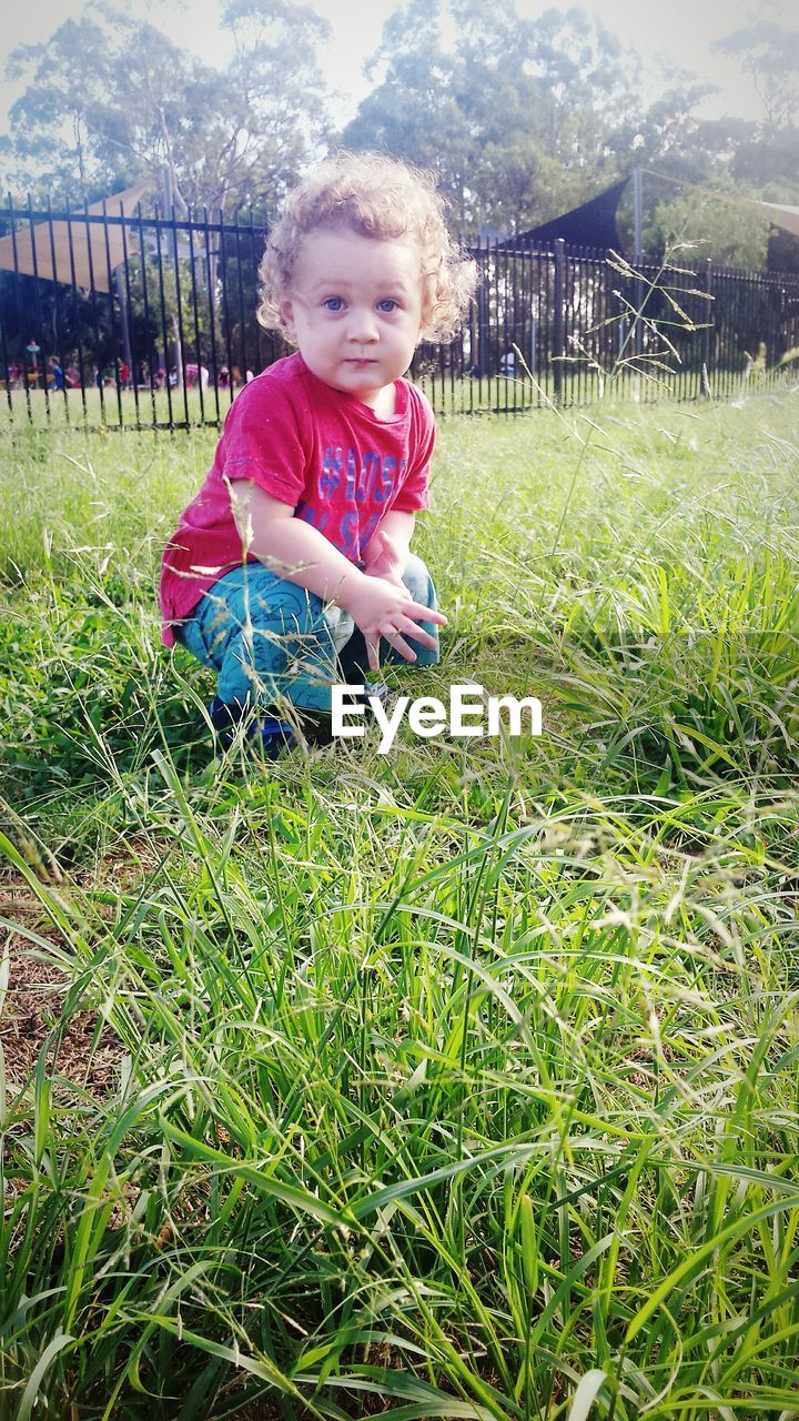 SMILING GIRL IN GRASS