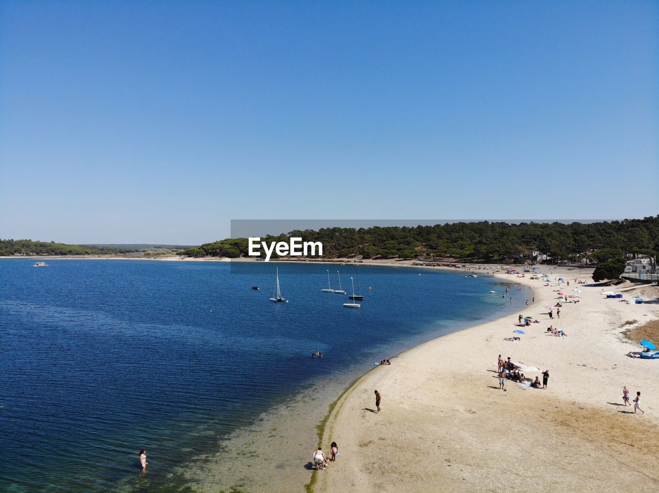 HIGH ANGLE VIEW OF PEOPLE ON BEACH AGAINST CLEAR SKY