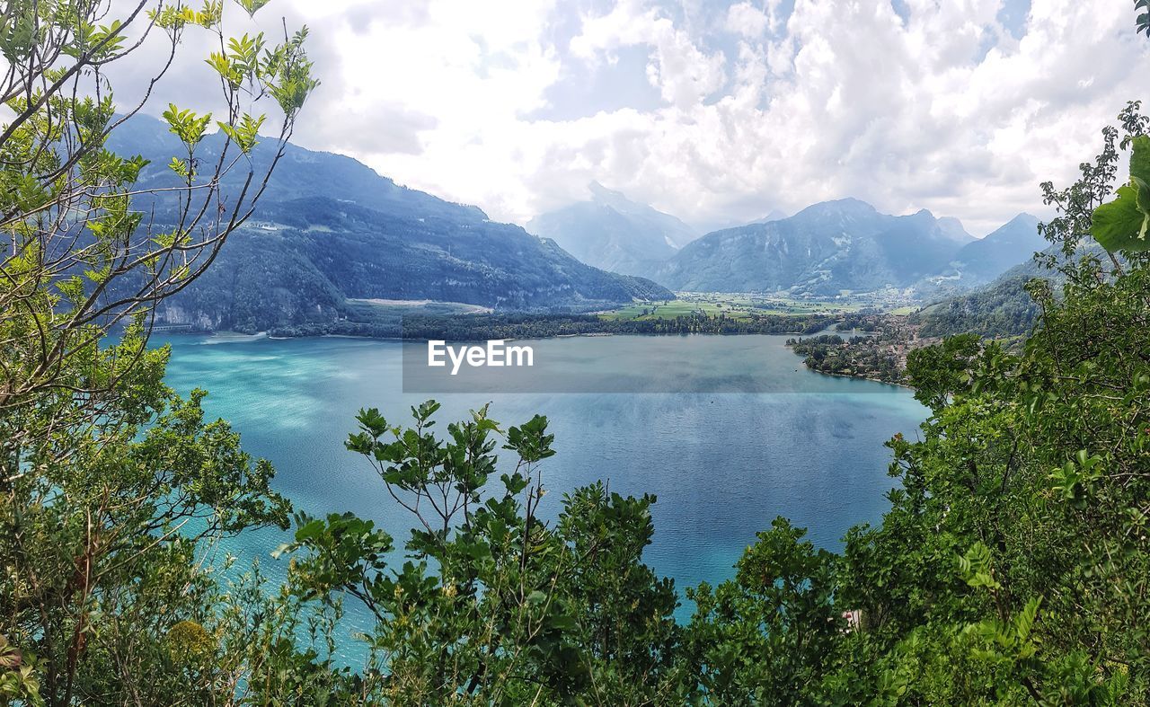 Scenic view of lake and mountains against sky