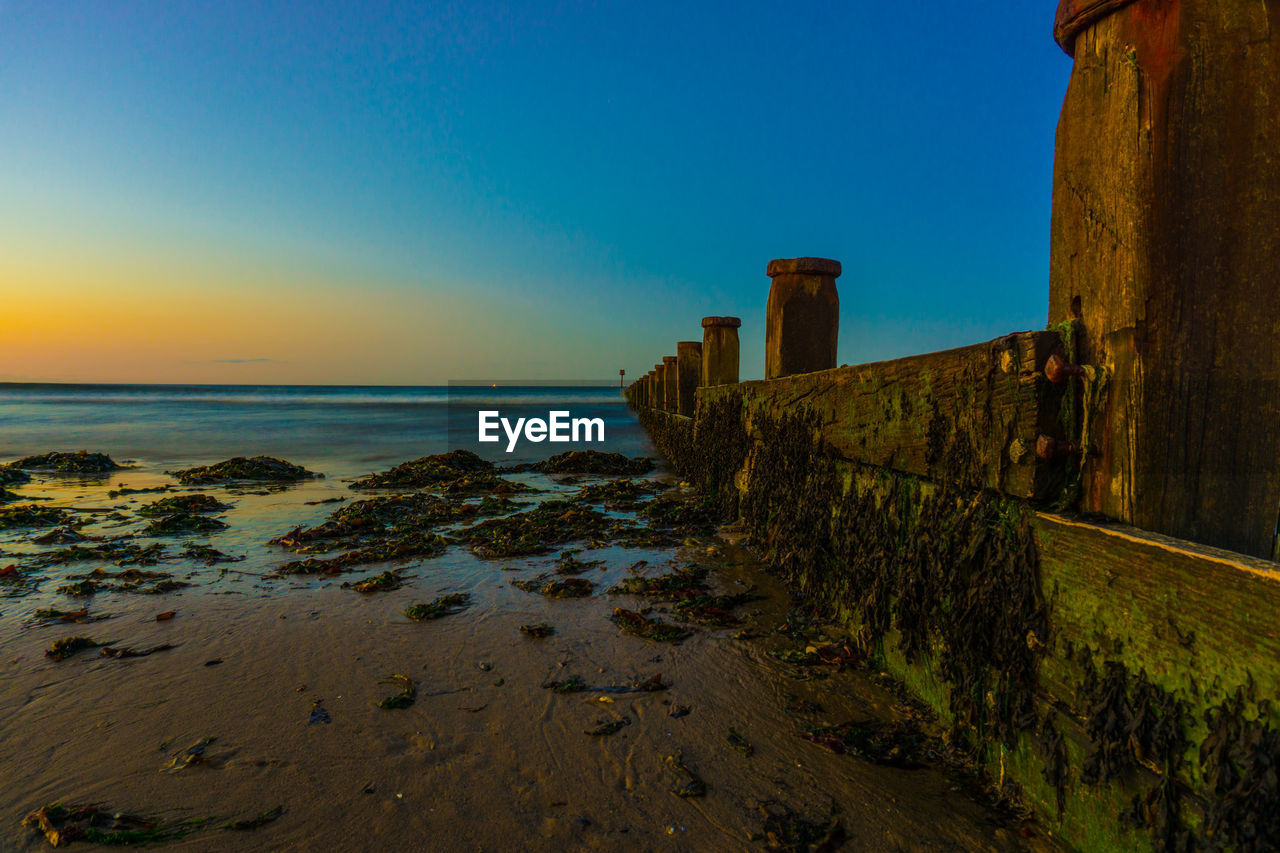 Scenic view of sea against clear blue sky